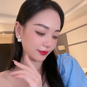 Close-up of model wearing silver double square earrings with shimmering rhinestones