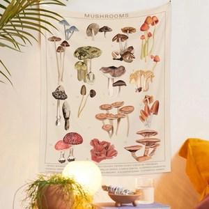 Detail view of a vintage mushroom tapestry with botanical names in a cozy room setting