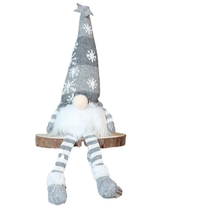 Christmas gnome doll with knitted hat and long legs on a rustic wood base