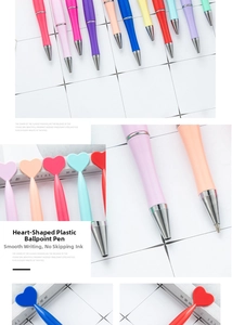 Detail view of heart-shaped plastic ballpoint pens in macaron colors for gifts