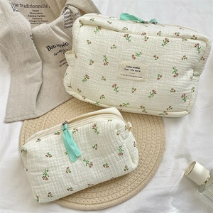 Detail of floral quilted cotton makeup bag set with zip and mint ribbon puller