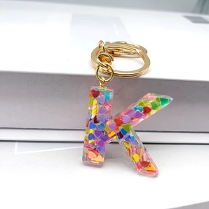 Creative letter K keychain pendant with colorful heart sequins in clear resin and gold ring