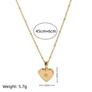 Gold locket necklace with heart-shaped zircon pendant and measurements on white background