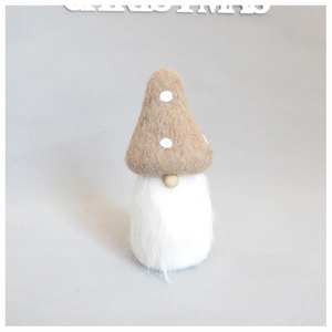 Macro detail of wool felt Christmas gnome ornament with white beard and wooden nose
