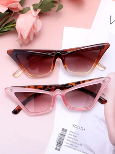 Detailed flat lay of cat eye sunglasses in tortoiseshell and pink on a stylish background