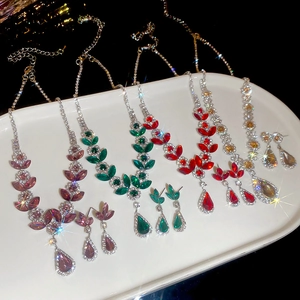 Close-up of diamond-encrusted floral jewelry set including necklaces and earrings