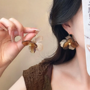 Detail view of bohemian acrylic flower earrings with gold hoop hooks and floral petals