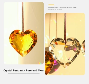 Detail of faceted heart crystal suncatcher pendant with red hanging cord and rainbow light effect