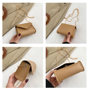 Detail view of brown crocodile pattern small square bag with golden chain strap