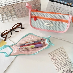 Close-up of translucent mesh pencil case with smooth zipper and side handle detail