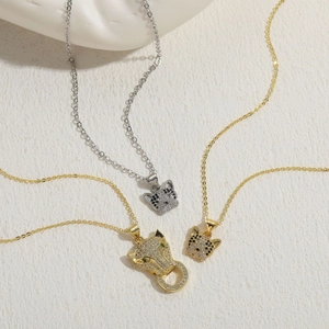 Detailed view of luxury leopard pendant necklaces with zircon inlay and green emerald eyes