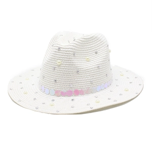 Close-up of white straw fedora with decorative pearls, rhinestones and iridescent sequins