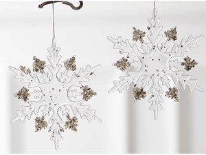 Macro shot of two transparent acrylic snowflakes with silver glitter edges and hanging cords