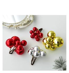 Close-up of Christmas decorative ball stems with red, gold and silver faceted baubles