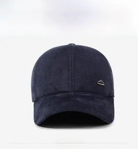 Close-up of winter baseball cap featuring herringbone texture and mountain metal logo