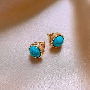 Retro turquoise and zircon gold-plated stud earrings on elegant silk fabric backdrops