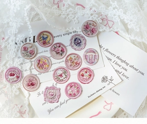Macro detail of vintage 3D resin stickers with pink floral and butterfly motifs