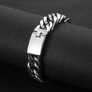 Polished silver stainless steel Cuban link bracelet for men with square clasp on black stand
