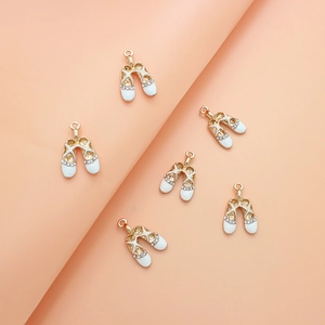 Detail of ballet shoe pendant with white enamel finish and sparkling rhinestones