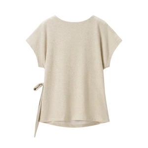 Detail of light beige knitted top showing textured cotton-linen fabric and side bow knot