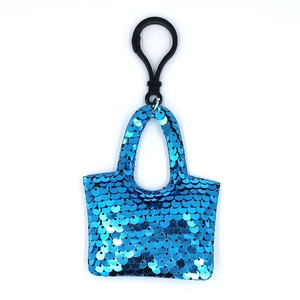 Blue sequin handbag keychain with black hook on white background for bag accessory
