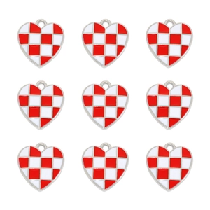 Macro view of heart-shaped alloy pendants featuring red and white checkerboard patterns