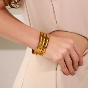 Three-piece 18K gold plated stainless steel bangles with star and moon charms on wrist