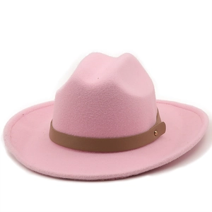 Detail of pink wool felt cowboy hat with brown leather band and metal rivets