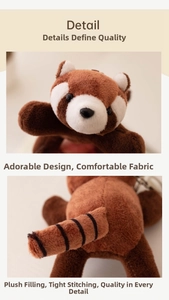 Close-up of red panda plush showing fine fur texture and striped tail details