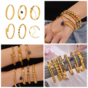Macro detail of 6-piece 18k gold plated bracelet set with enamel and skull charms