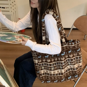 Detail of plush tote bag with vintage jacquard pattern in an artistic studio setting