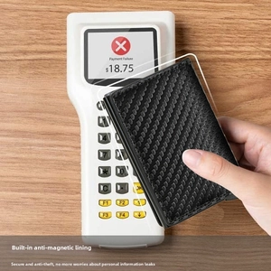 Close-up of RFID blocking carbon fiber wallet protecting cards from a POS terminal scan