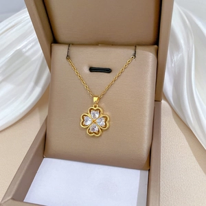 Detail of luxury clover pendant necklace with sparkling heart-shaped zirconia crystals