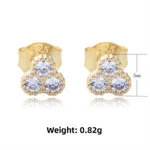 Detail view of gold-plated S925 silver stud earrings with three round cubic zirconia stones