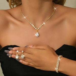 Detailed view of elegant gold-plated zircon necklace and earring set on a model