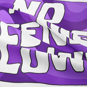 Close-up of Bohemian tapestry fabric showing purple ripple patterns and bold text details