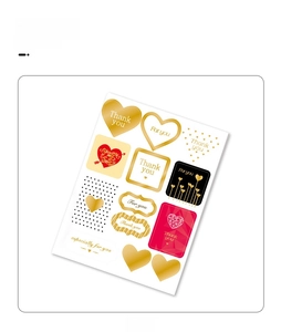 Detail of assorted gold and red decorative gift tags with Thank You heart patterns