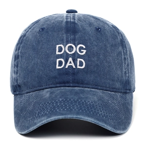 Detailed frontal view of white DOG DAD embroidery on a retro washed navy baseball cap