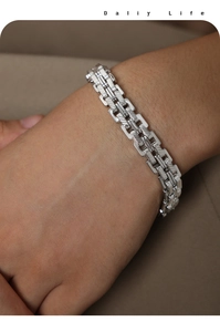 Close-up of industrial style silver titanium steel bracelet on wrist with textured links