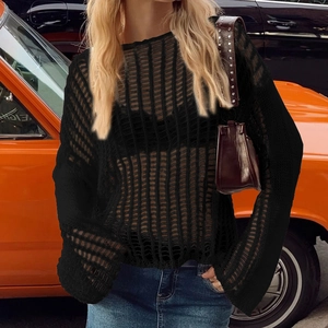 Detailed view of black crochet knit texture and flared sleeves on a summer cover-up