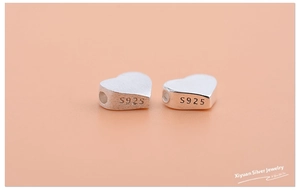 Macro shot of S925 sterling silver heart-shaped spacer beads for DIY jewelry making