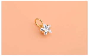 Macro shot of 925 silver gold star pendant with sparkling zircon for DIY jewelry