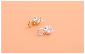 Detailed close-up of mini star pendants featuring sparkling cubic zirconia and bail rings