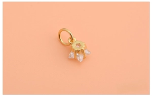 Macro detail of 925 silver star pendant with cubic zirconia and gold plating finish