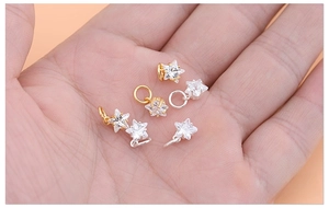 Detailed view of mini 925 sterling silver star pendants with sparkling zircon stones