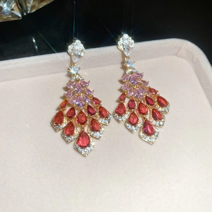Macro shot of chandelier tassel earrings featuring pink pear-shaped cubic zirconia gems