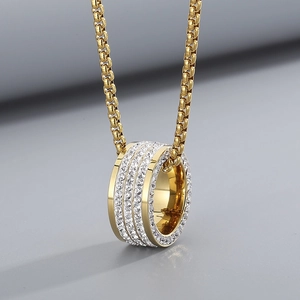 Close-up of hip hop gold chunky chain necklace with triple row crystal paved ring pendant
