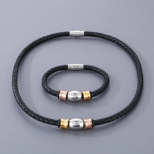 Detail of black braided leather jewelry set with tri-color beads and magnetic clasp