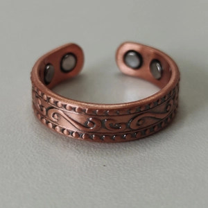 Detailed macro view of the inner magnetic stones on a 6mm red copper health ring