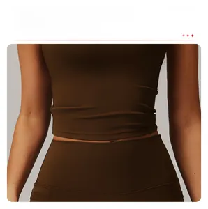 Detail view of coffee brown yoga top showing elongated hem and tummy control shaping fit